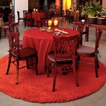 Event furniture display, round table with color coordinated linens, rolled utensils and lit candles